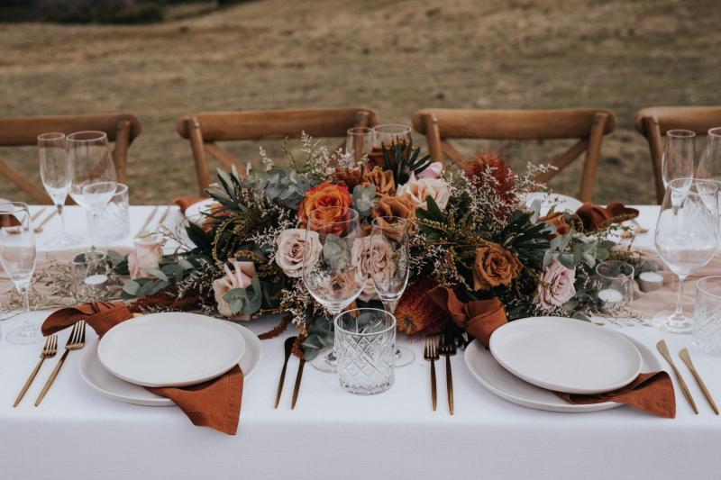 KWH real bride Ashleigh's tablescape with burnt orange roses and copper settings by The Floral Criteria