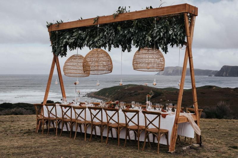 KWH real bride Ashleigh's wooden reception table with hanging lanterns.