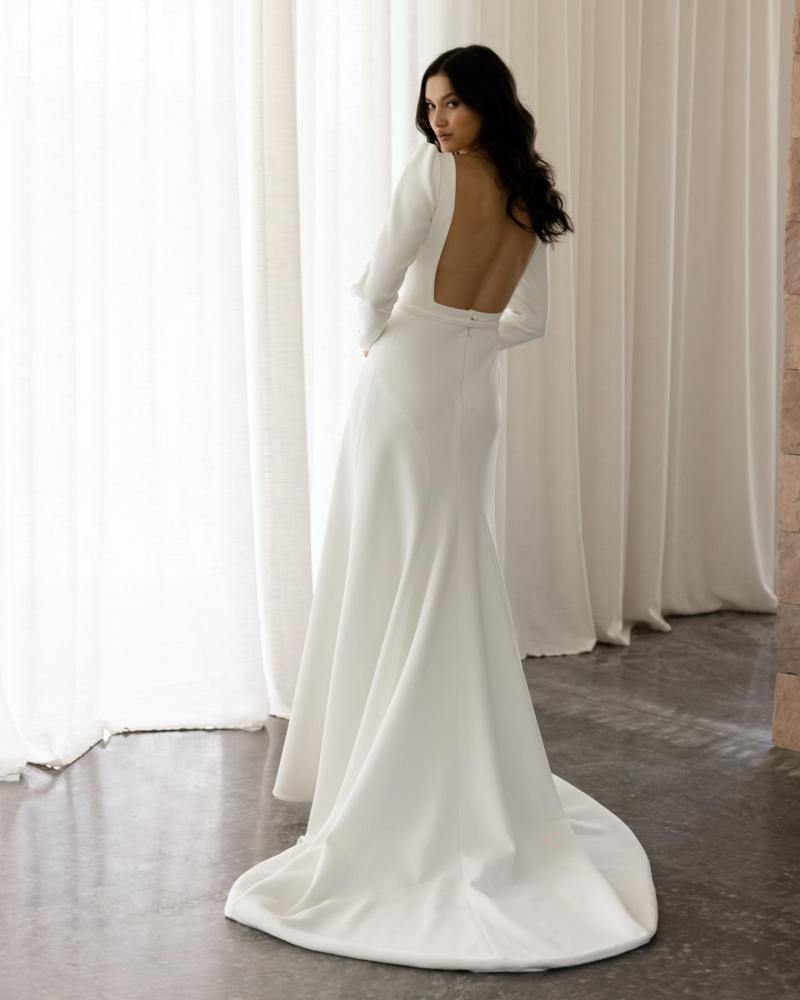 The Gwen & Fern gown by Karen Willis Holmes, a straight, plunging neckline crepe wedding dress with straps or long sleeves. and fit and flare skirt.