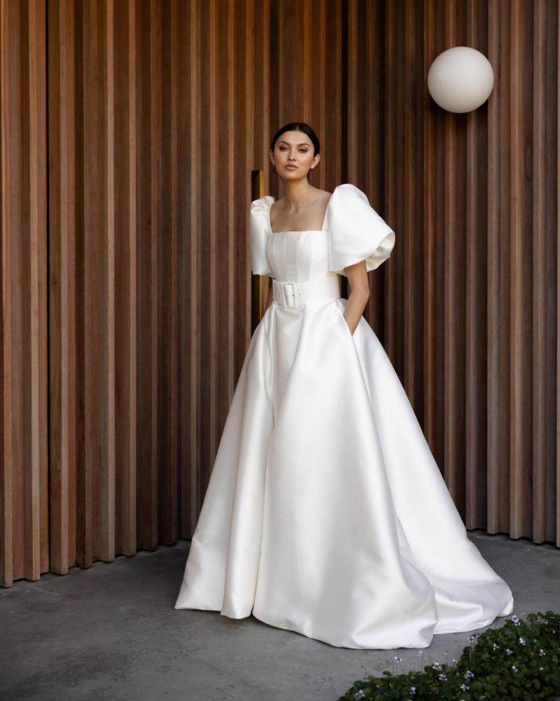 The Diana bodice and Elizabeth Skirt by Karen Willis Holmes, a simple, straight neckline wedding dress with a traditional A line skirt with pockets with straps and an open back