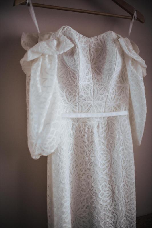 Upclose detail shot of KWH real bride Tess's Vivienne wedding dress; a modern lace wedding dress with structured bodice and puff sleeves.