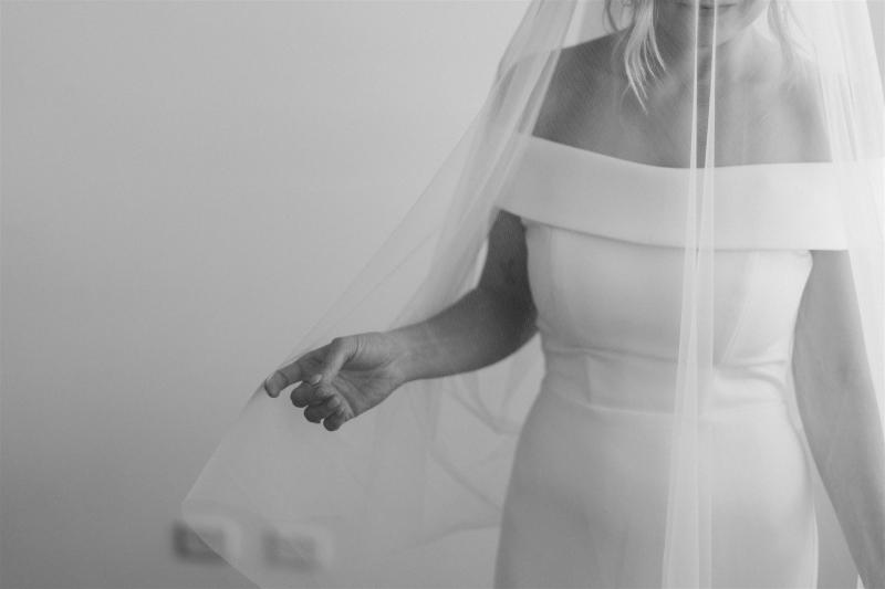 B&W image of KWH real bride Shelley wearing her simple off the shoulder wedding dress, Lauren, with her Claude veil.