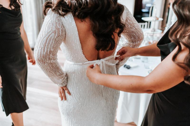 KWH real bride Katherine's Margareta gown hanging; she is a modern beaded wedding dress.