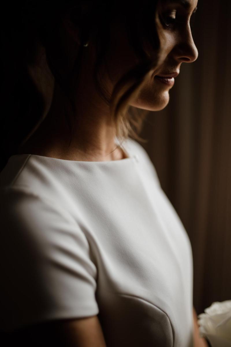 Upclose bridal portrait of KWH real bride Jacqui wearing her Clarissa gown, a high neck cap sleeve fit and flare wedding dress.