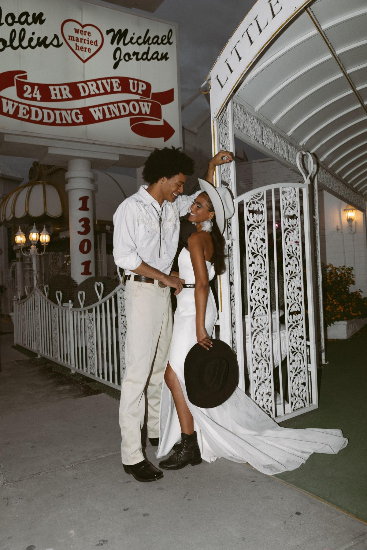 Couple's elopement at A Little White Chapel in Vegas wearing the Grace gown by Karen Willis Holmes and cowboy Hat