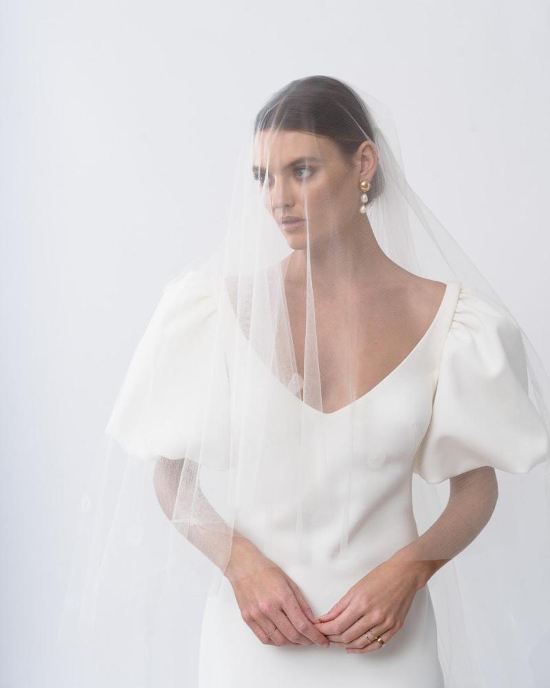 The Shelby gown and Fleur Wedding Veil by Karen Willis Holmes, a simple crepe fit and flare wedding dress with bubble sleeves.