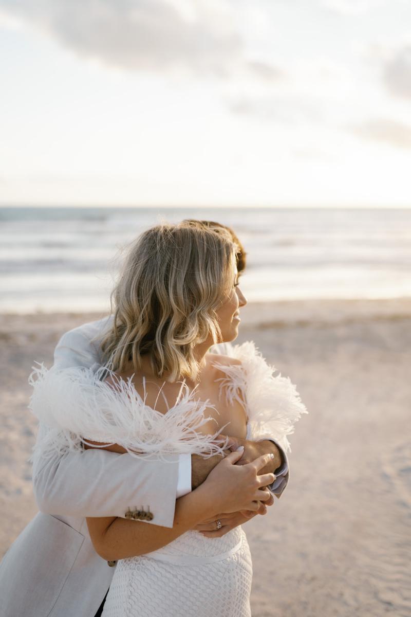 Annabelle Gown by Karen Willis Holmes, an off the shoulder lace wedding dress worn by this beautfiul bride on the beach