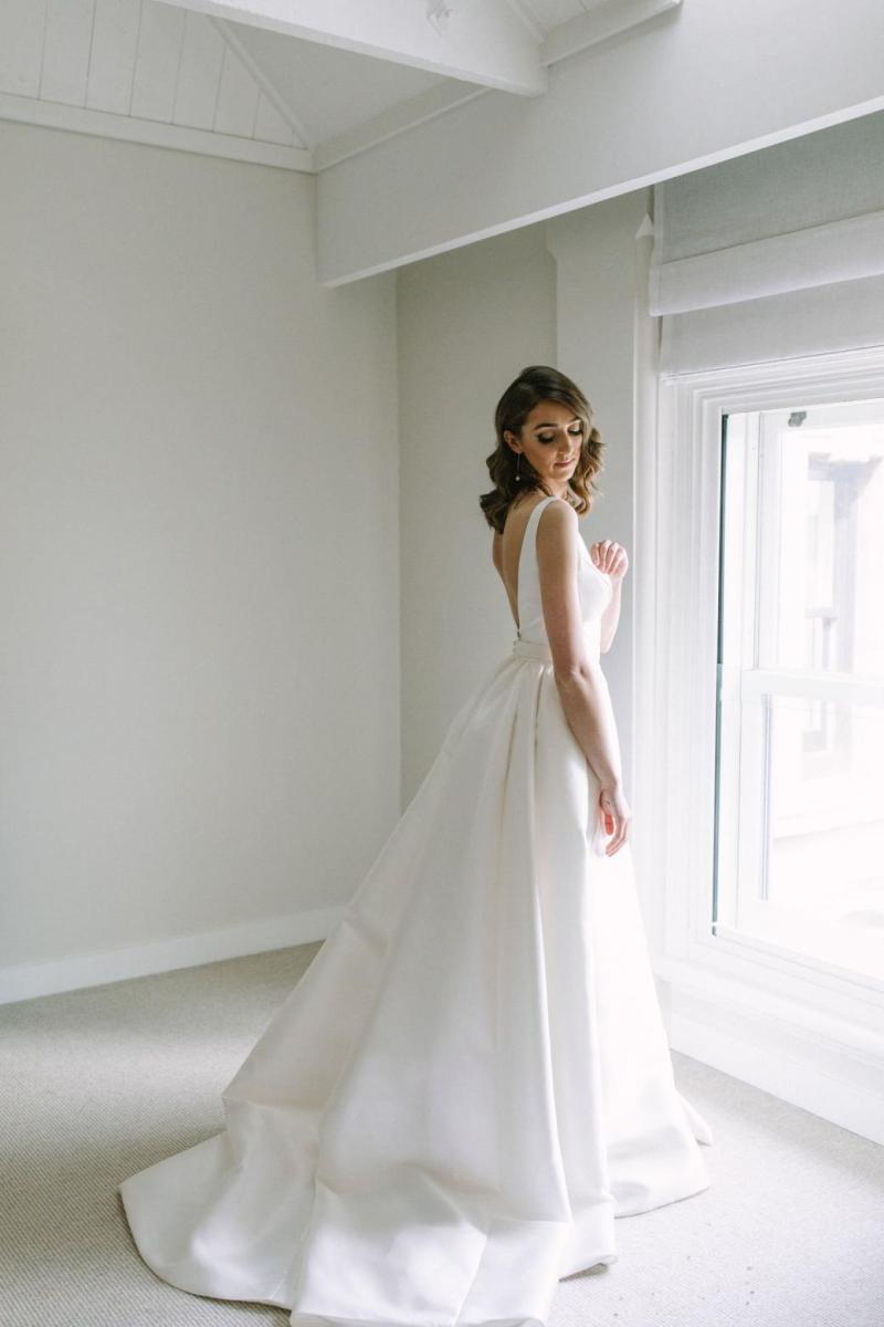 Real bride Courtney wore the Bespoke Leonie/Camille wedding dress by Karen Willis Holmes.