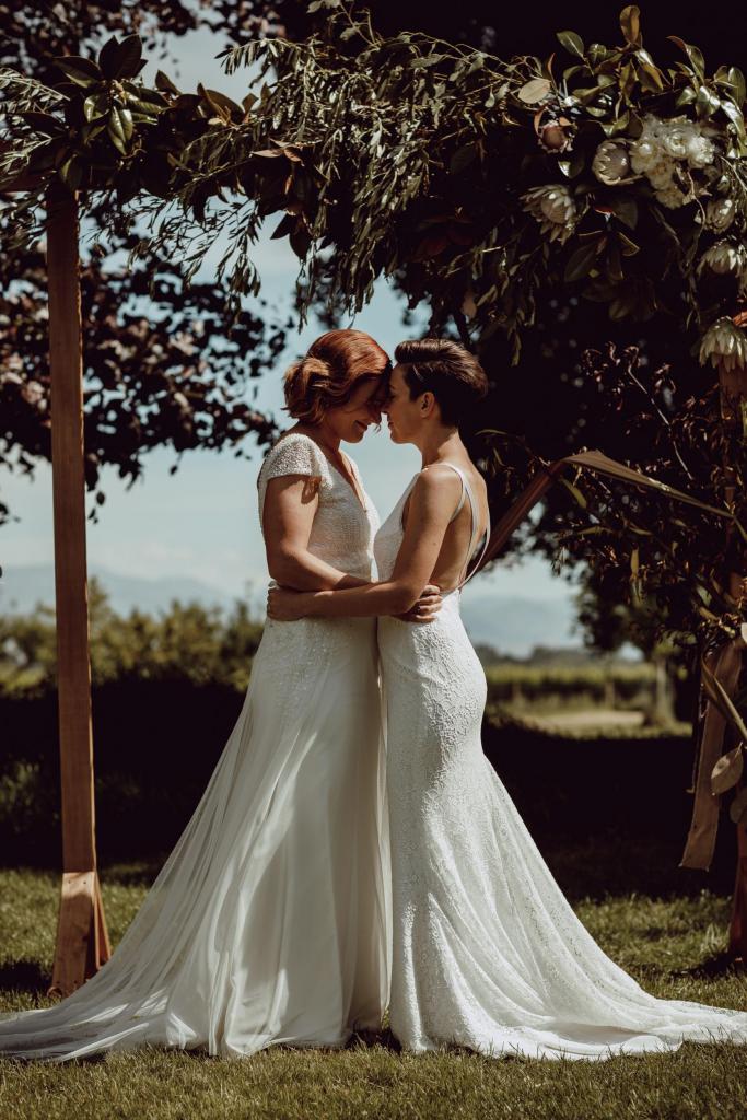 Real brides Georgie & Liz wore the Luxe Valeria wedding dress and the Wild Hearts Kristy wedding dress by Karen Willis Holmes.