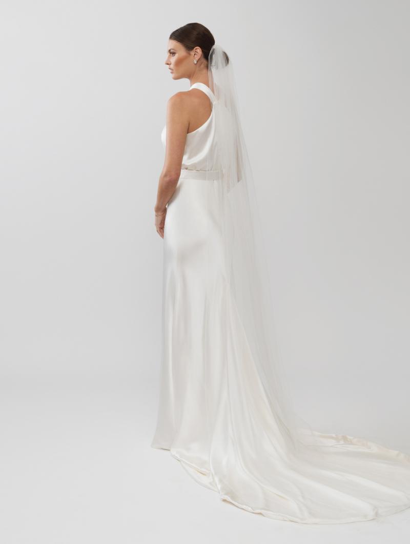 The Tammy gown and Lucienne veil 250cm by Karen Willis Holmes, a high neckline, simple satin bias cut wedding dress with a split skirt.