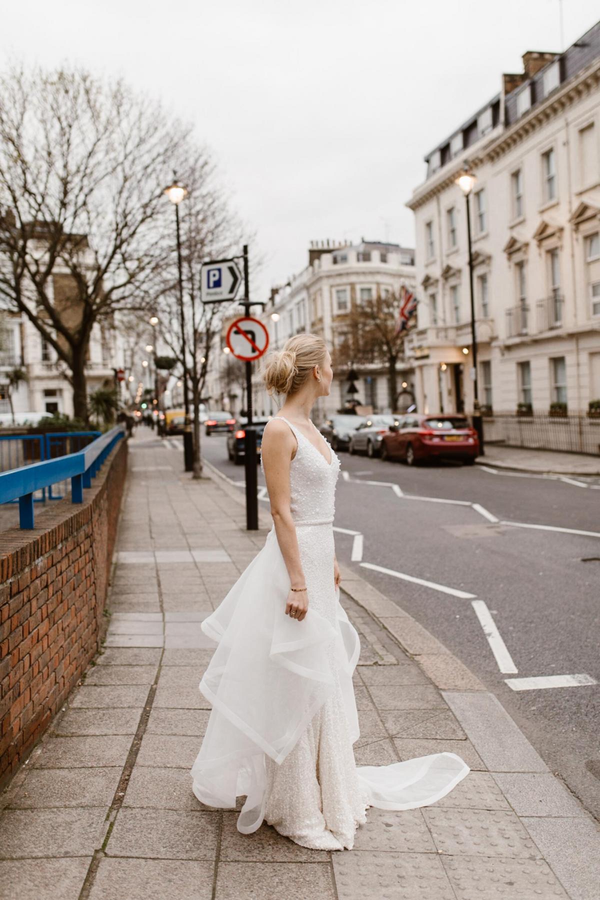 The Lola gown by Karen Willis Holmes, v-neck beaded wedding dress shown with detachable train.