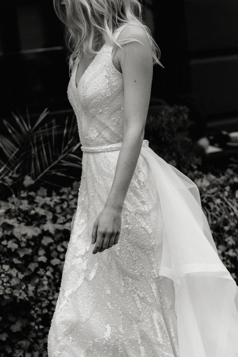 The Rhiannon gown by Karen Willis Holmes, fit and flare v-neck wedding dress shown with detachable train.