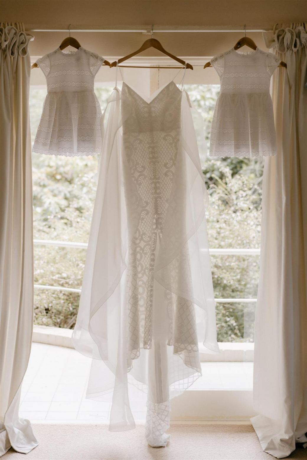 Elodie wedding dress by Karen Willis Holmes hanging up morning of wedding with elated bride