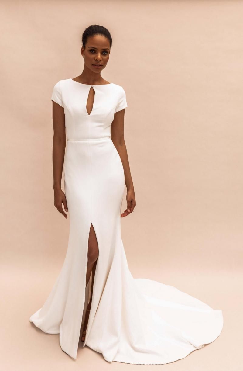 The Clarissa gown by Karen Willis Holmes, simple high neck cap sleeve wedding dress with slit.