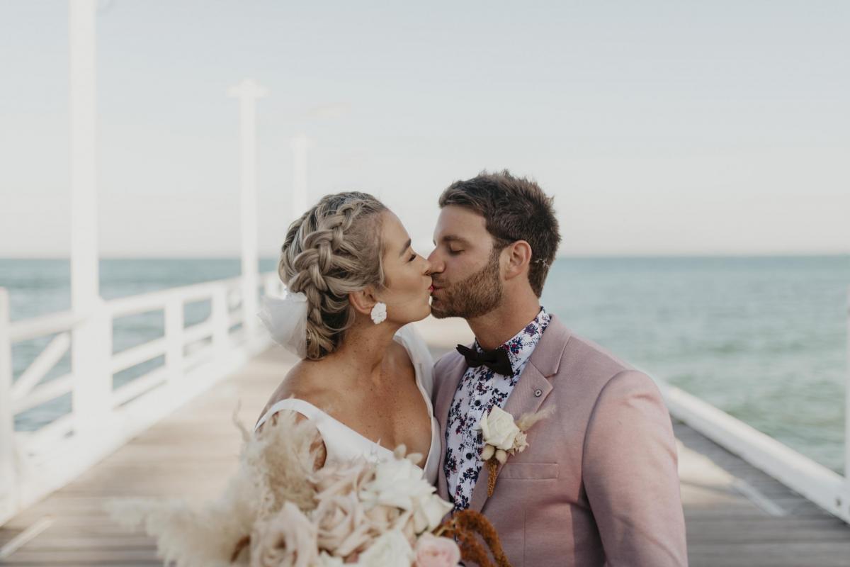 Kelsi wears the Leonie Melanie gown; a V-neck, A-line, simple wedding dress, for her Queensland wedding