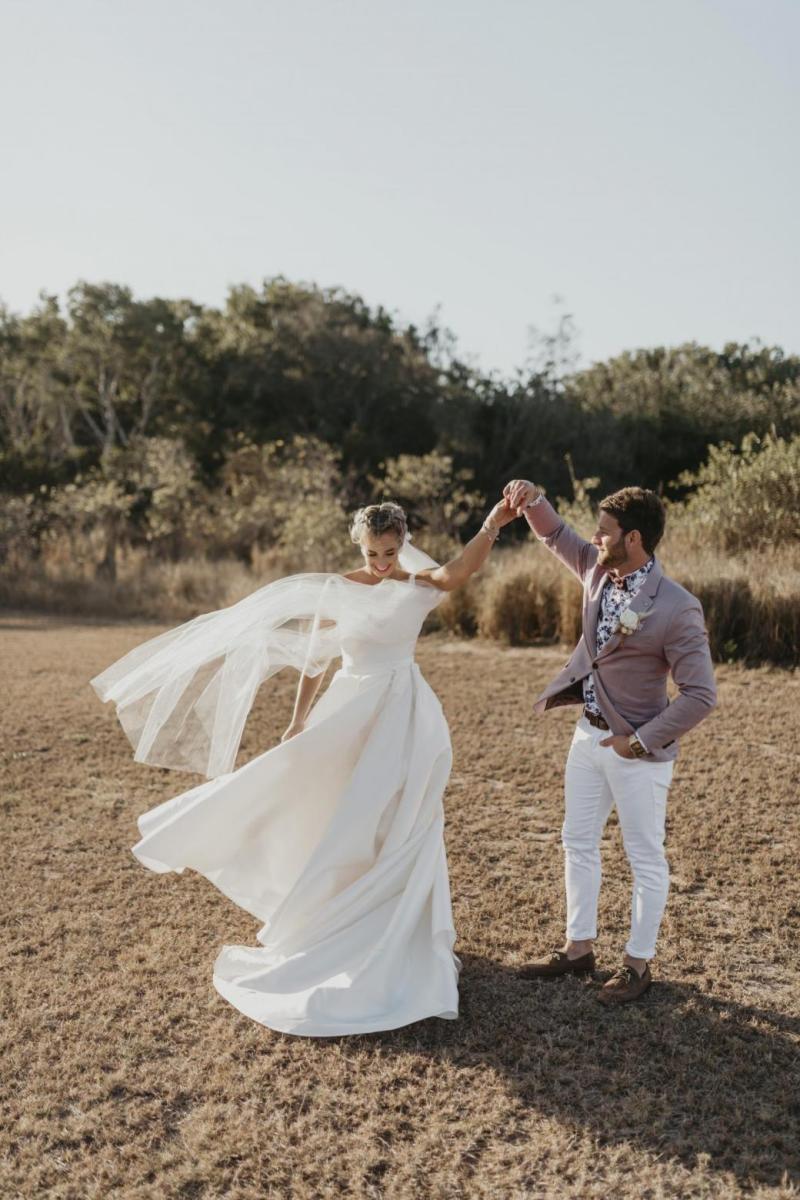 Kelsi wears the Leonie Melanie gown; a V-neck, A-line, simple wedding dress, for her Queensland wedding