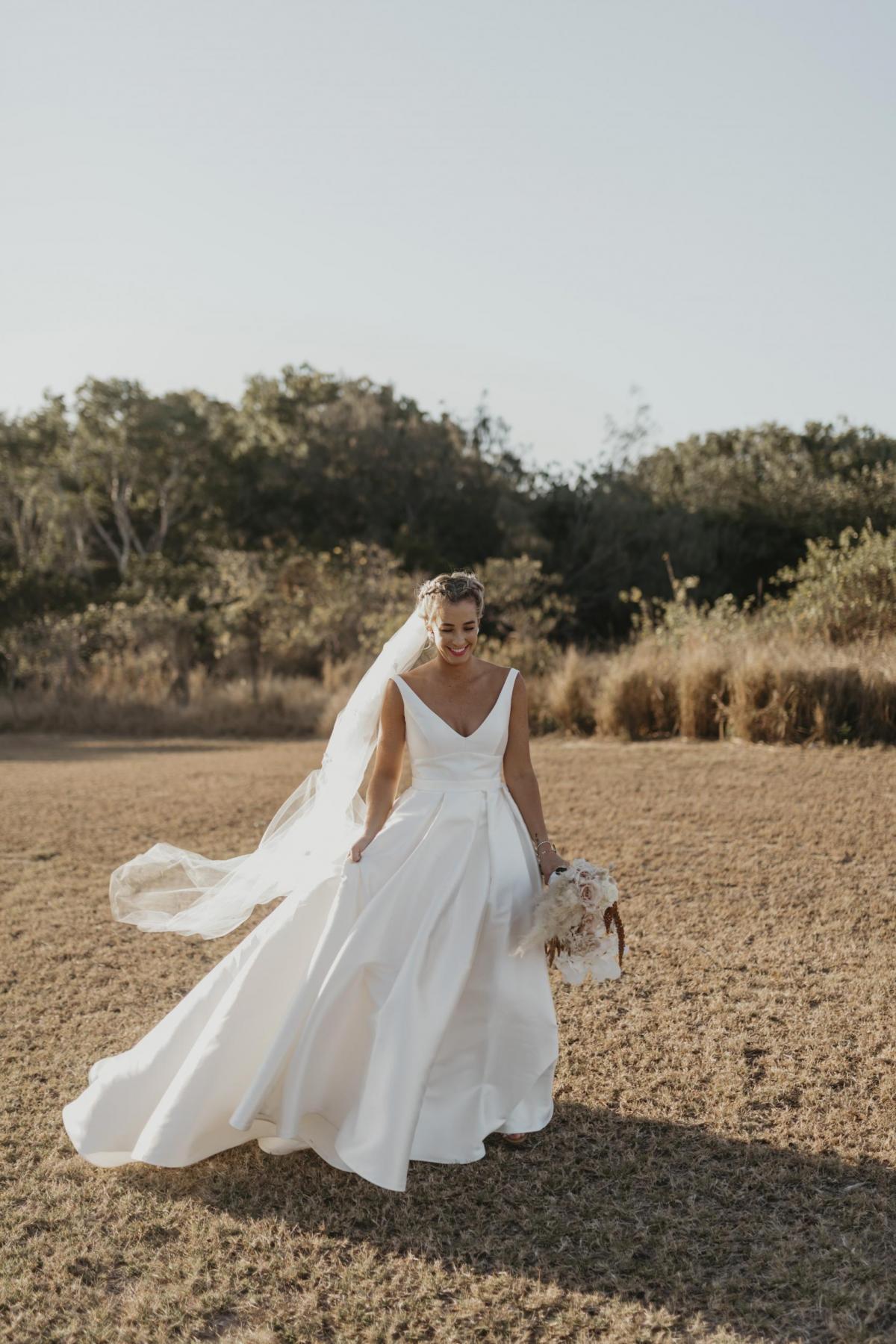 Kelsi wears the Leonie Melanie gown; a V-neck, A-line, simple wedding dress, for her Queensland wedding