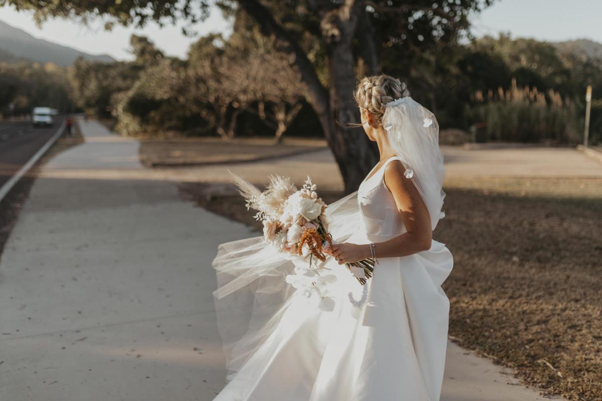 Kelsi wears the Leonie Melanie gown; a V-neck, A-line, simple wedding dress, for her Queensland wedding