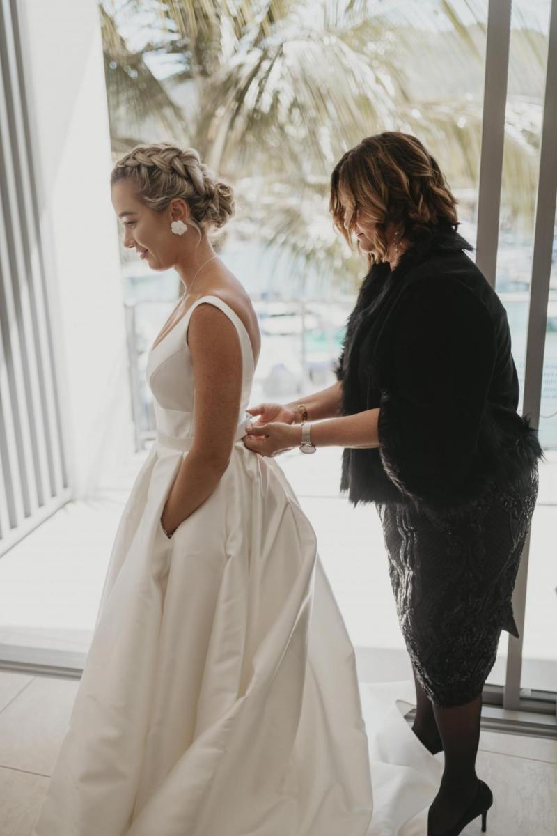 Kelsi wears the Leonie Melanie gown; a V-neck, A-line, simple wedding dress, for her Queensland wedding