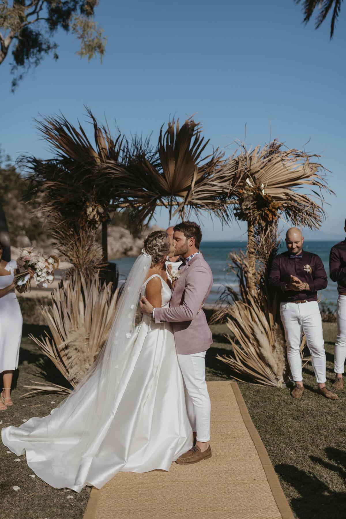 Kelsi wears the Leonie Melanie gown; a V-neck, A-line, simple wedding dress, for her Queensland wedding