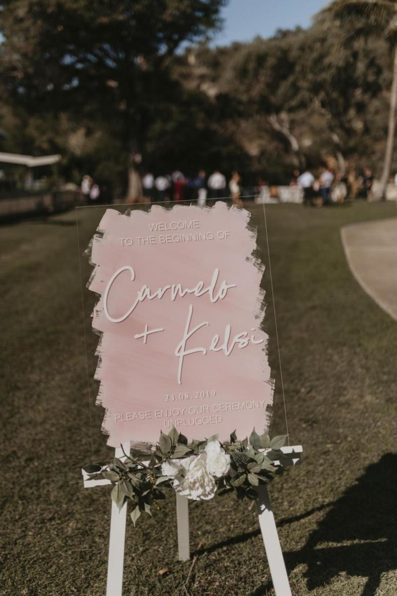 Kelsi wears the Leonie Melanie gown; a V-neck, A-line, simple wedding dress, for her Queensland wedding with natural bridal bouquet