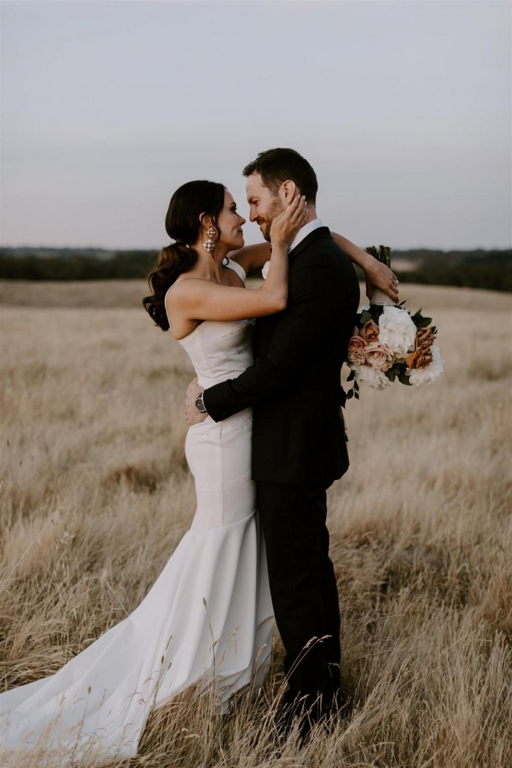 KWH bride Rachael and husband Adam sharing intimate moment. Rachael wears the minimal Violet gown.