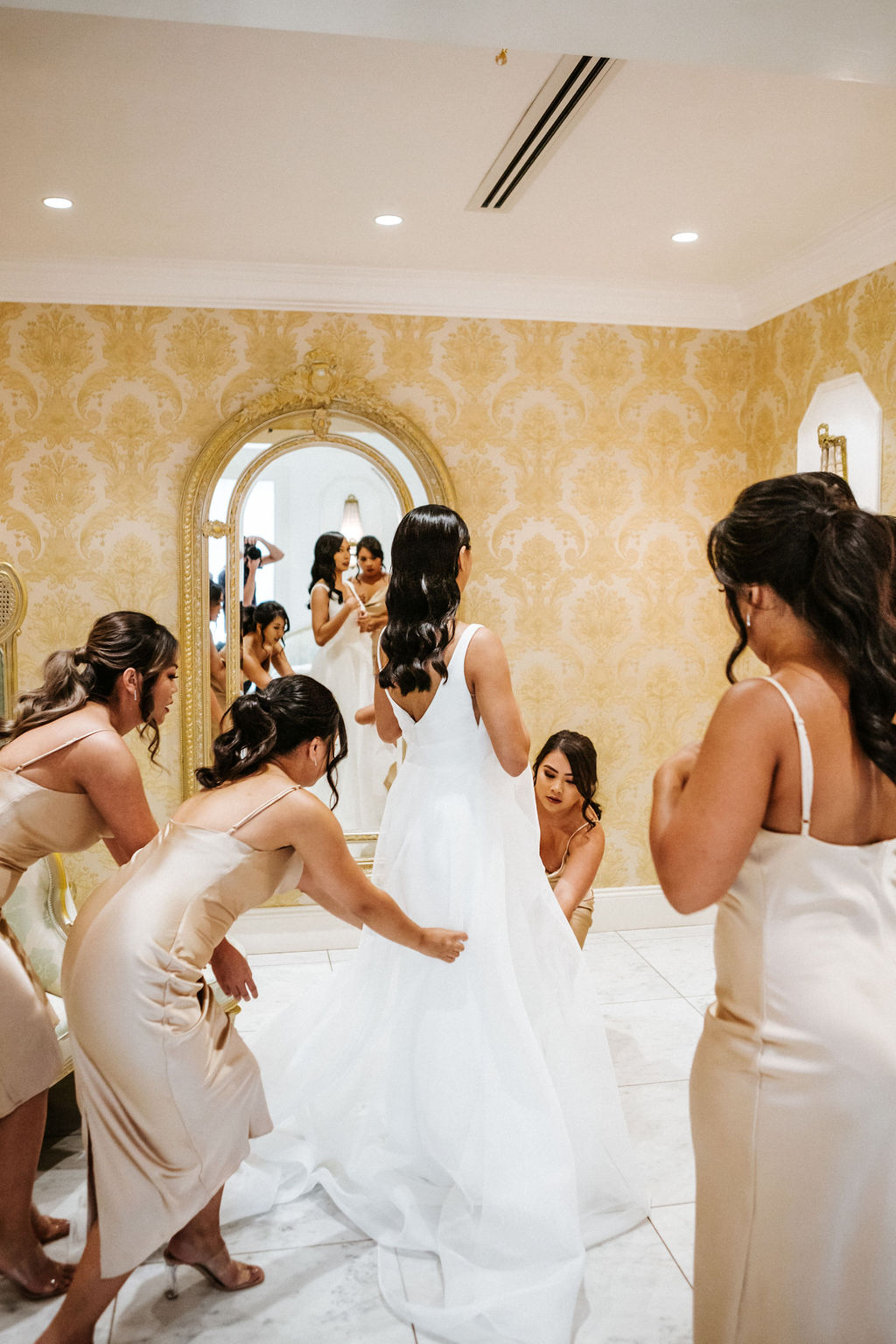 KWH bride Win getting ready with bridesmaids for tropical wedding, wearing the Aisha gown by Karen Willis Holmes.