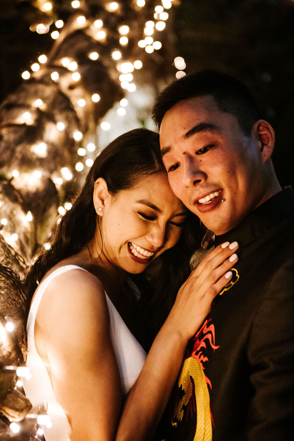 Intimate shot of KWH bride Win & husband Julian at tropical wedding.