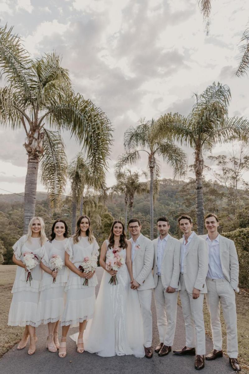 Leah celebrating her wedding with husband; wearing the FONTANNE wedding dress by Karen Willis Holmes.