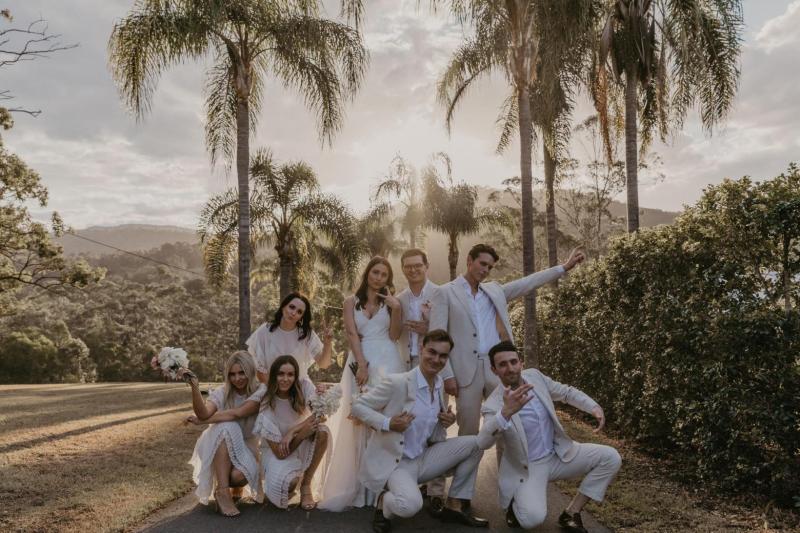 Leah celebrating her wedding with husband; wearing the FONTANNE wedding dress by Karen Willis Holmes.