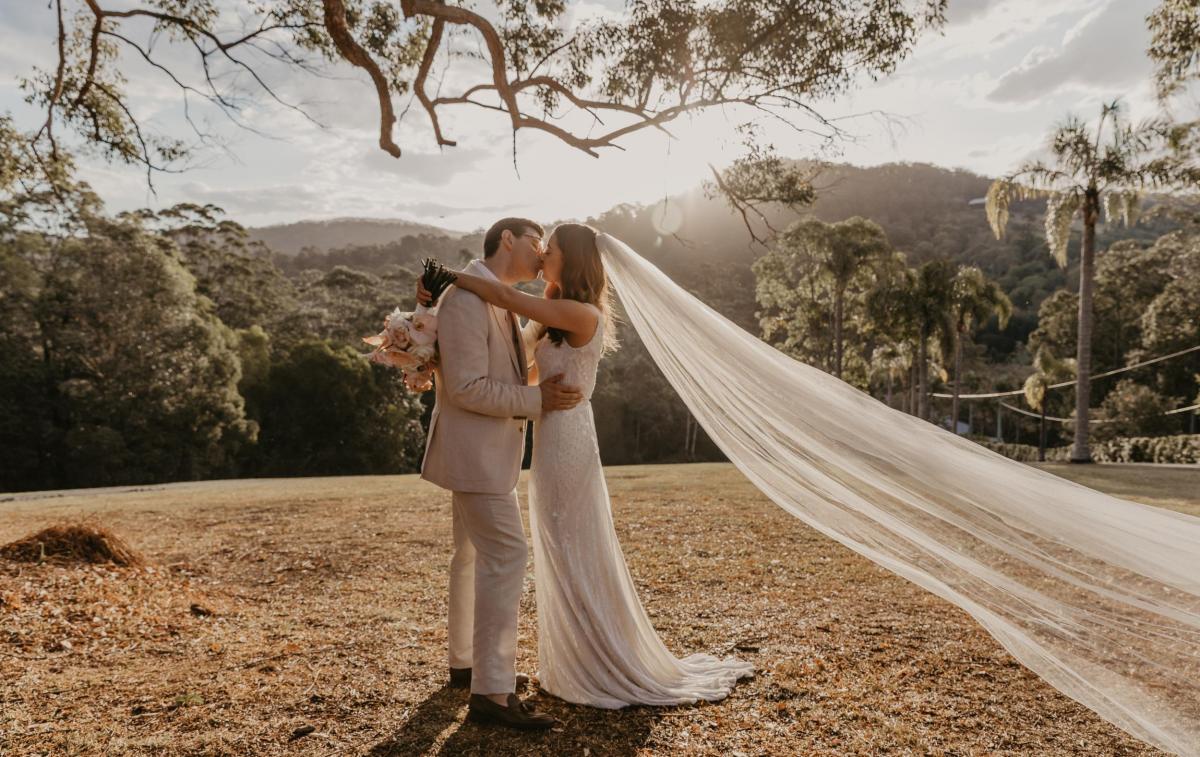 KWH bride Leah with new husband Sam; wearing the FONTANNE beaded wedding dress and long veil.