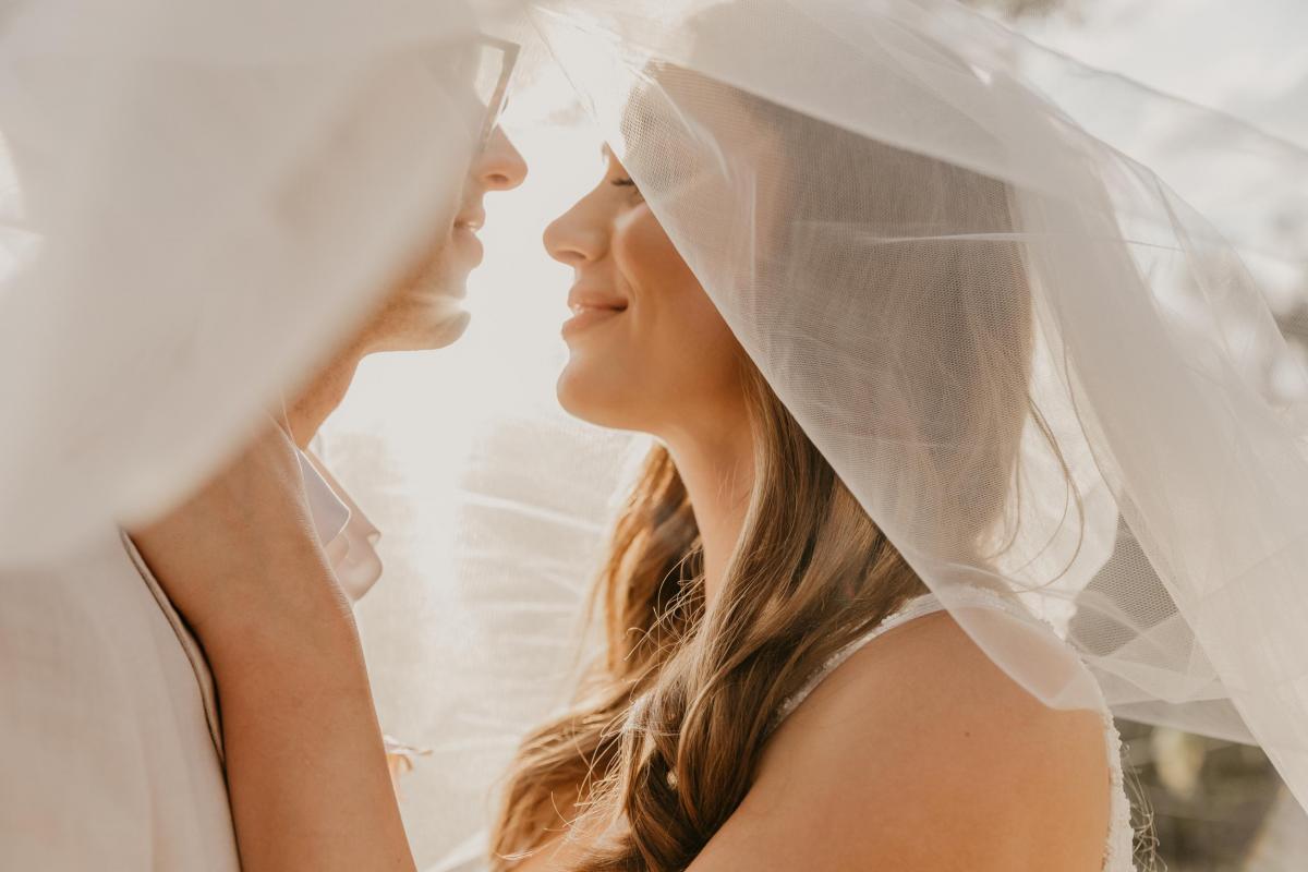 Intimate picture of KWH bride Leah & Sam under wedding veil.