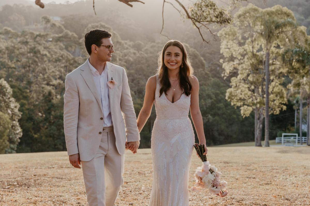 KWH bride Leah with new husband Sam; wearing the FONTANNE beaded wedding dress featuring a V-neck bodice and bias cut skirt.