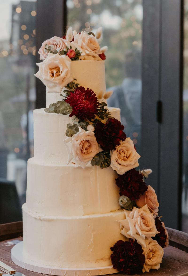 KWH bride Leah's white wedding cake; featuring red and pink roses.