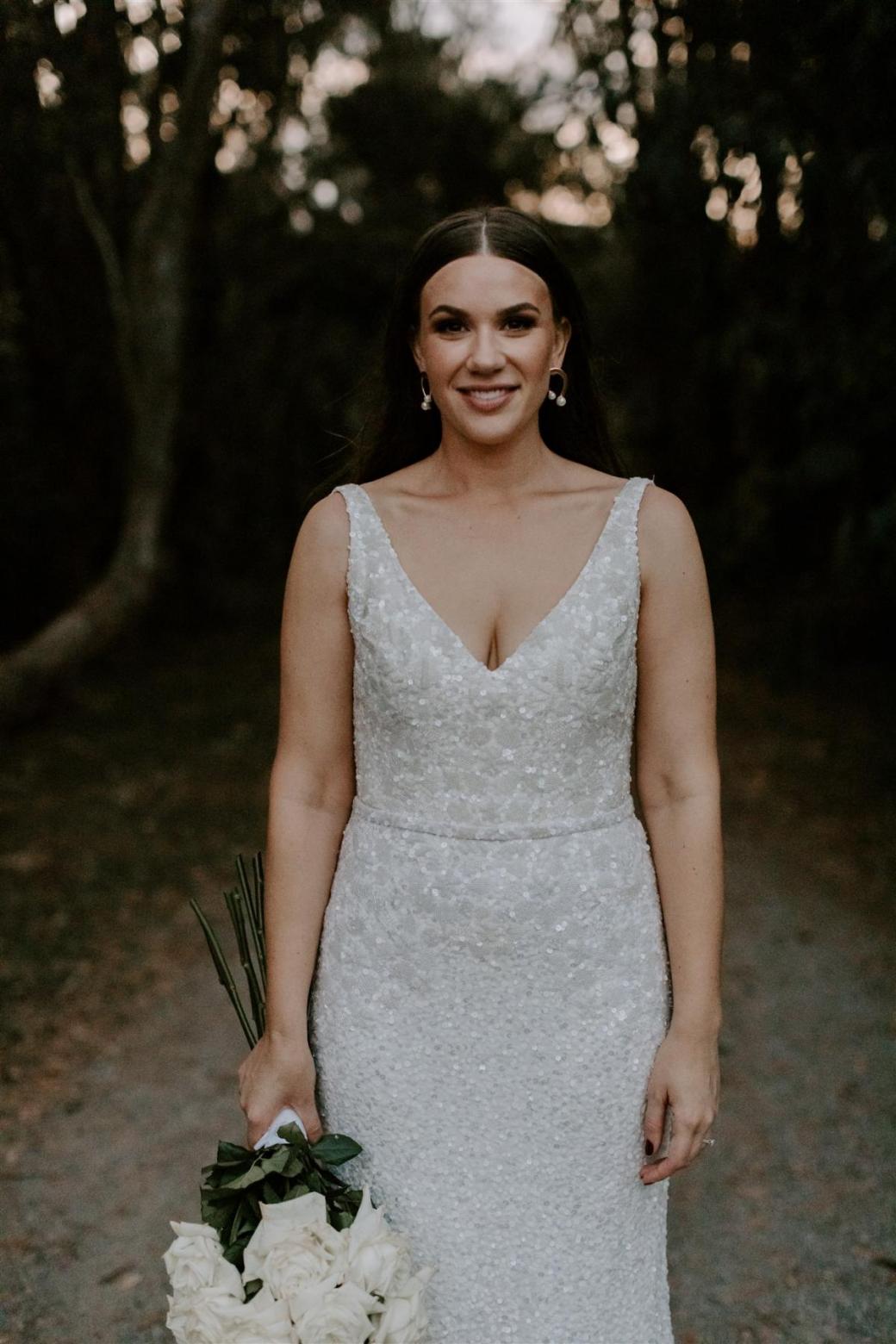 KWH bride Jemma wears the GEORGINA wedding dress; A beaded dress with a V-neck and low back.