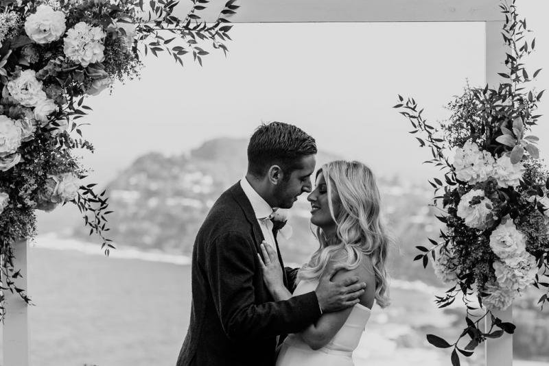 KWH bride Celeste & husband kissing at altar of wedding ceremony.