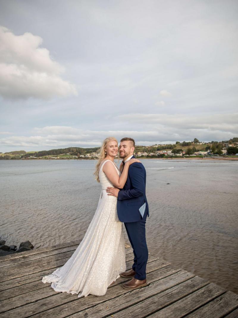 Bride and groom at their COVID-19 wedding on the water