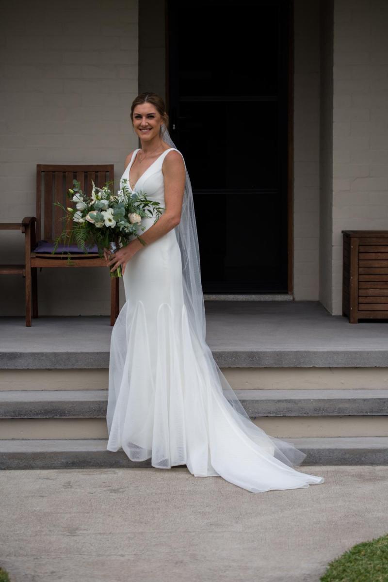 Olivia wears Tatiana; a simple V-neck wedding dress by Karen Willis Holmes
