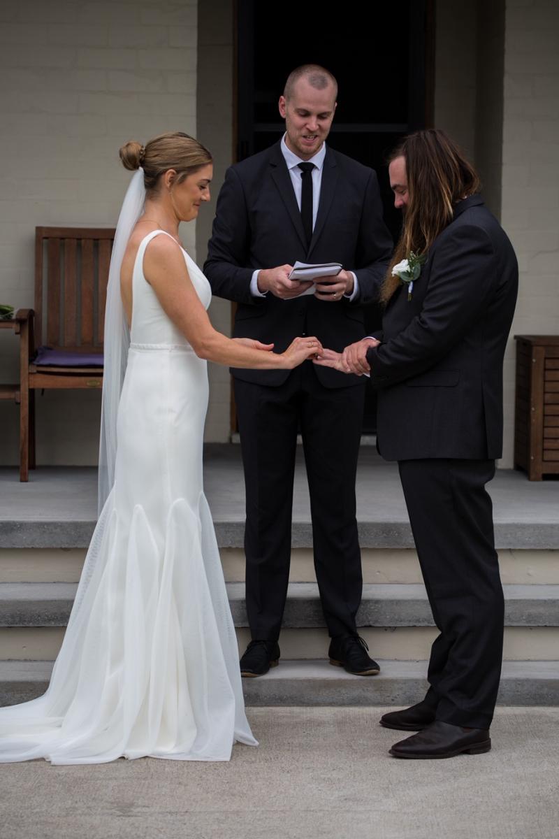 Bride and groom at the ceremony of their COVID-19 wedding, on the front porch