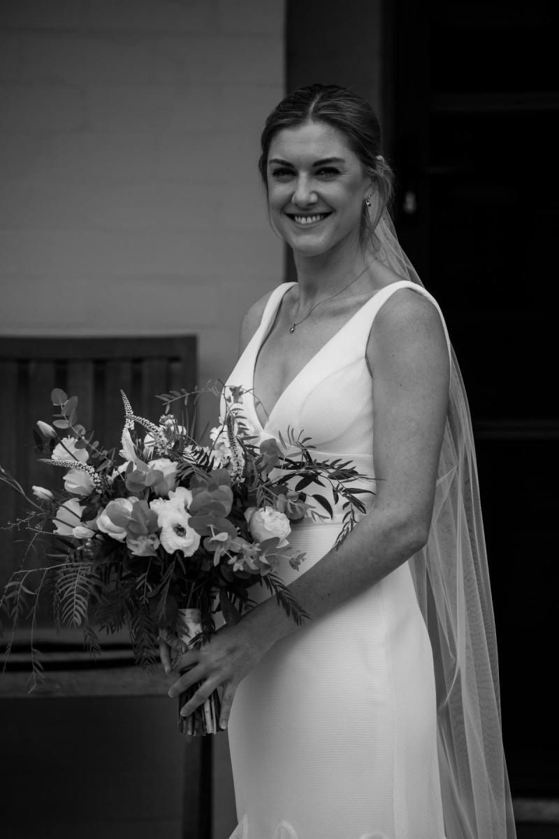 Olivia wears Tatiana; a simple V-neck wedding dress by Karen Willis Holmes