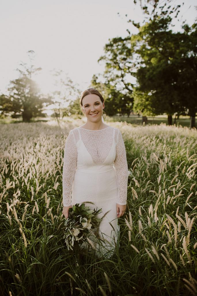 KWH bride Cassie celebrating real wedding in the JEMMA gown; a long sleeve lace wedding dress with lace sleeves.