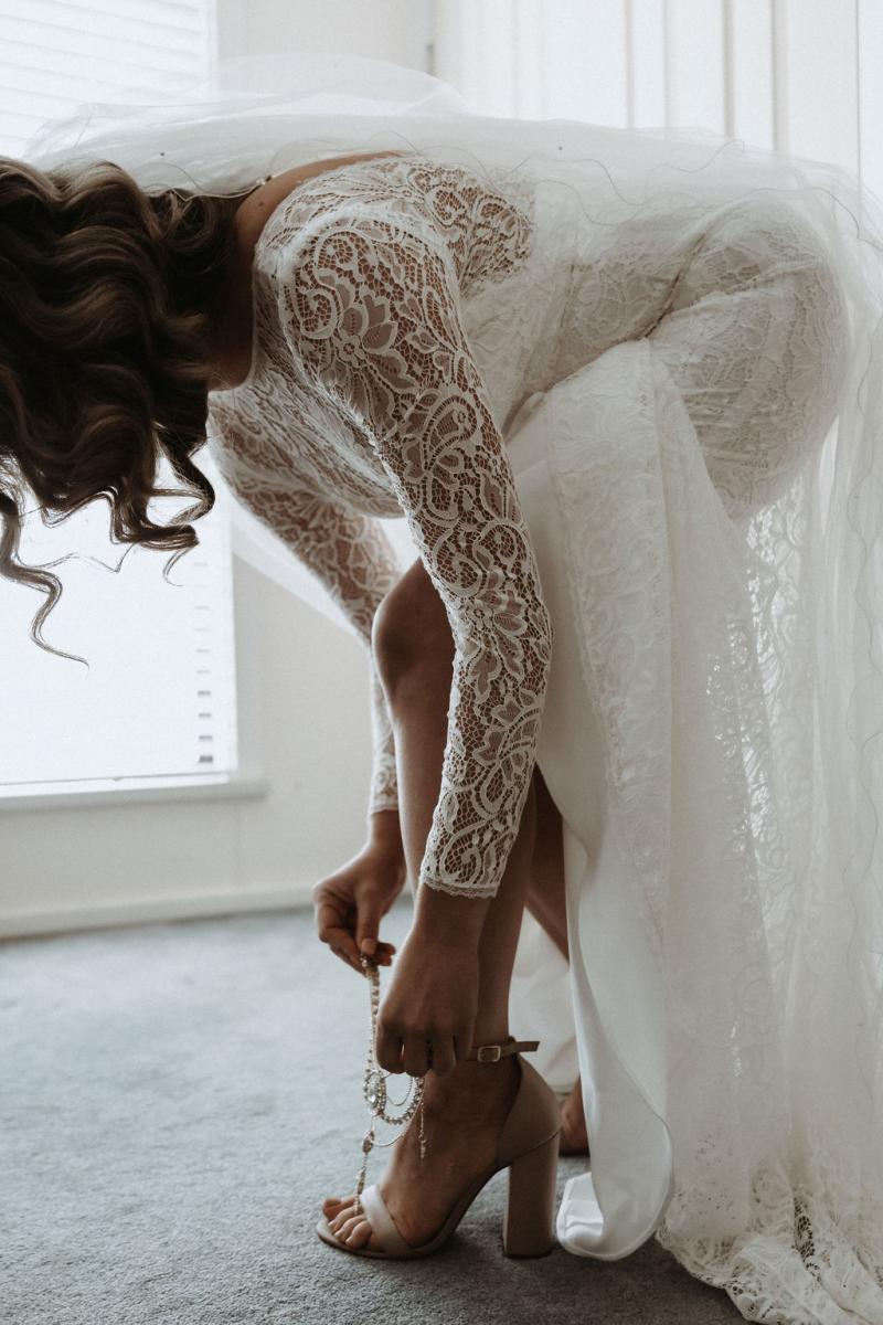 Karen Willis Holmes bride Meagan wearing the Wild Hearts Karina gown; a flattering long-sleeved lace wedding dress for the modern bohemian bride.
