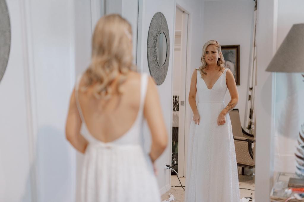 Karen Willis Holmes bride Megan getting ready for romantic wedding, wearing the Nadia gown; an edgy and romantic lace wedding dress with a V-neck and side split.