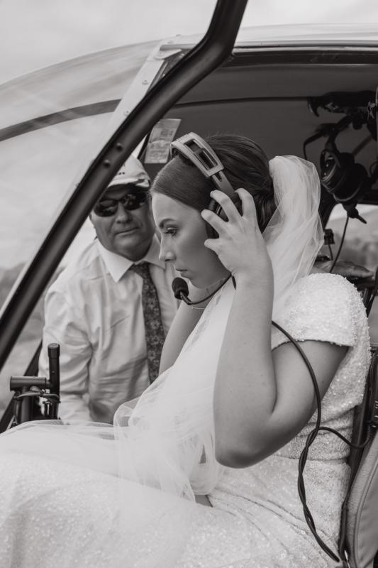 Real bride Elly wears the Luxe Annette gown in her helicopter ride for wedding portraits.