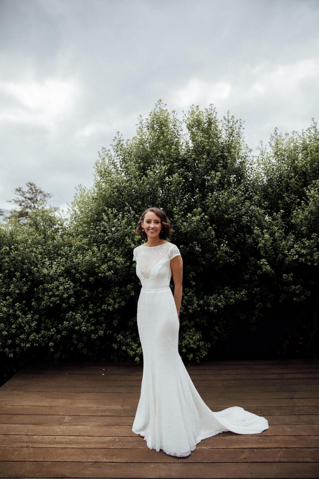Real bride Amy wears the Wild Heart's Jemma gown by Karen Willis Holmes; with a sheer bodice and figure hugging skirt.
