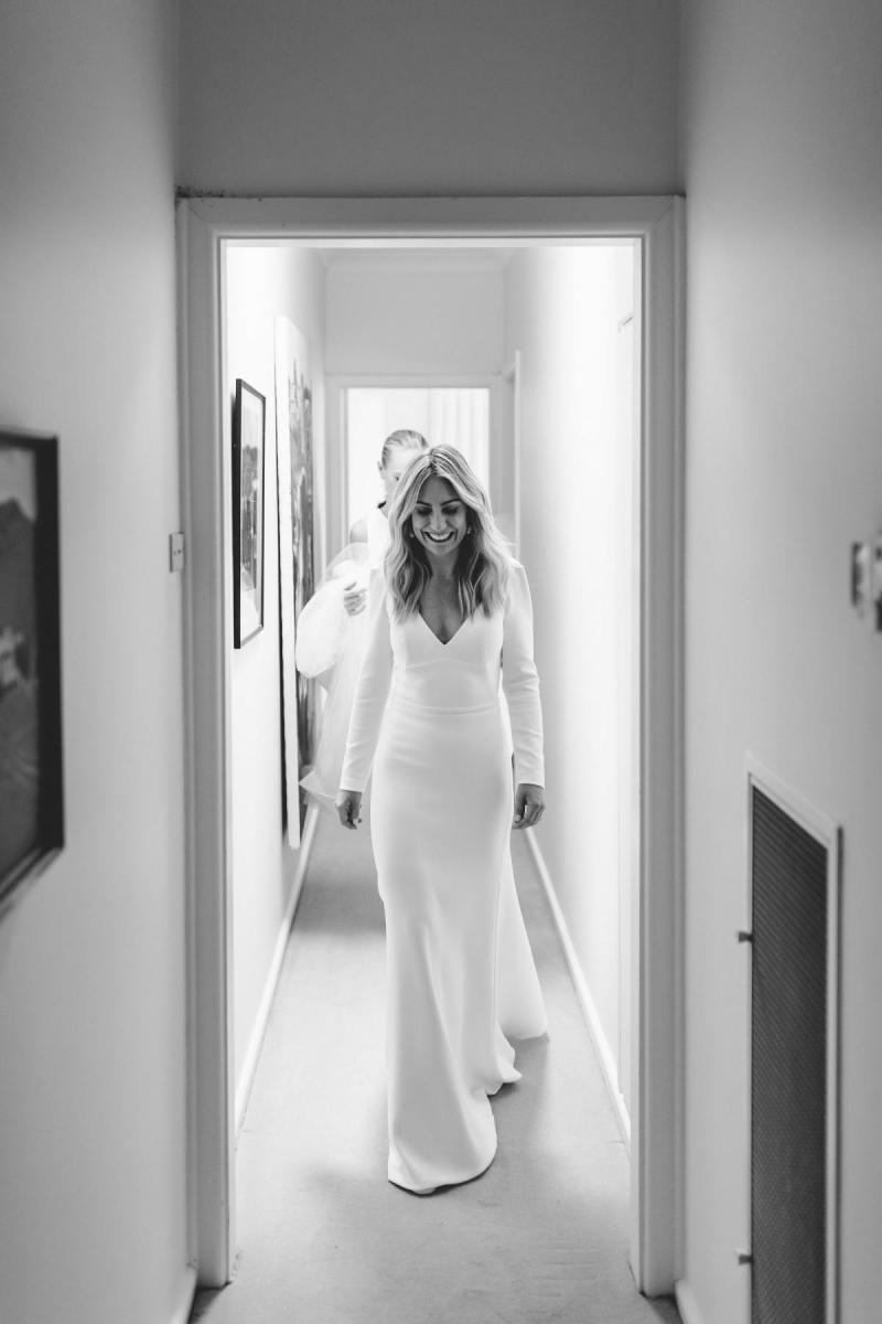 Real bride Annabelle wears the Aubrey gown; a simple long-sleeved wedding dress from the Wild Hearts Collection, designed by Karen Willis Holmes.