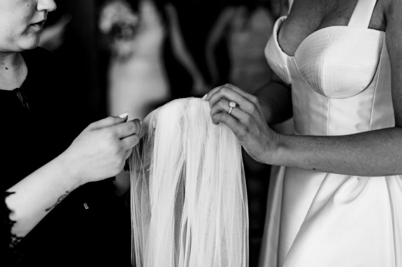 Bride wears Bespoke bustier wedding dress Blake Camille by Karen Willis Holmes, getting ready with veil