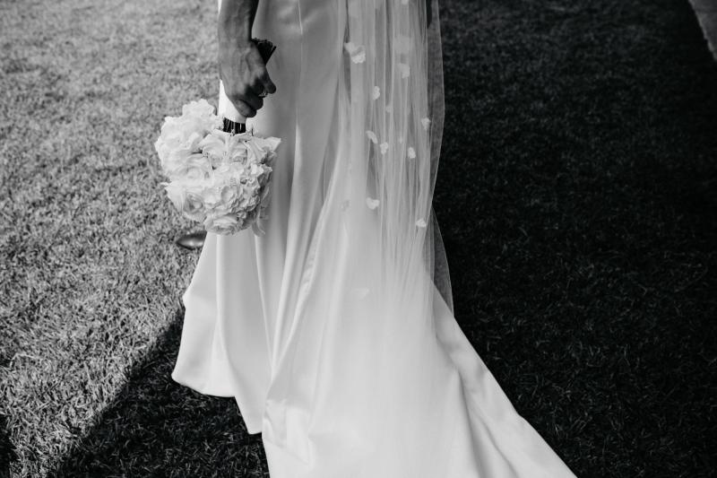 Close up of brides Bespoke bustier wedding dress Blake Camille by Karen Willis Holmes against elegant painting