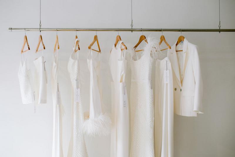 Range of ivory wedding dresses hanging on racks at Karen Willis Holmes bridal boutique
