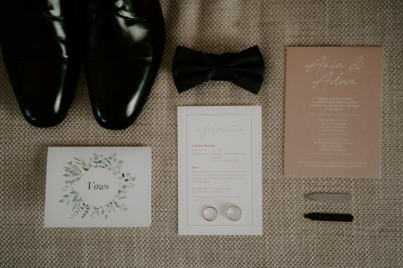 Flat lay of wedding details invitations and shoes